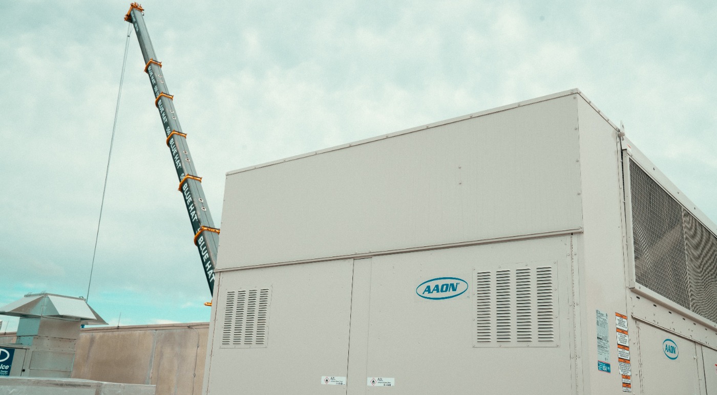 Large Aaon unit set on arena roof with crane